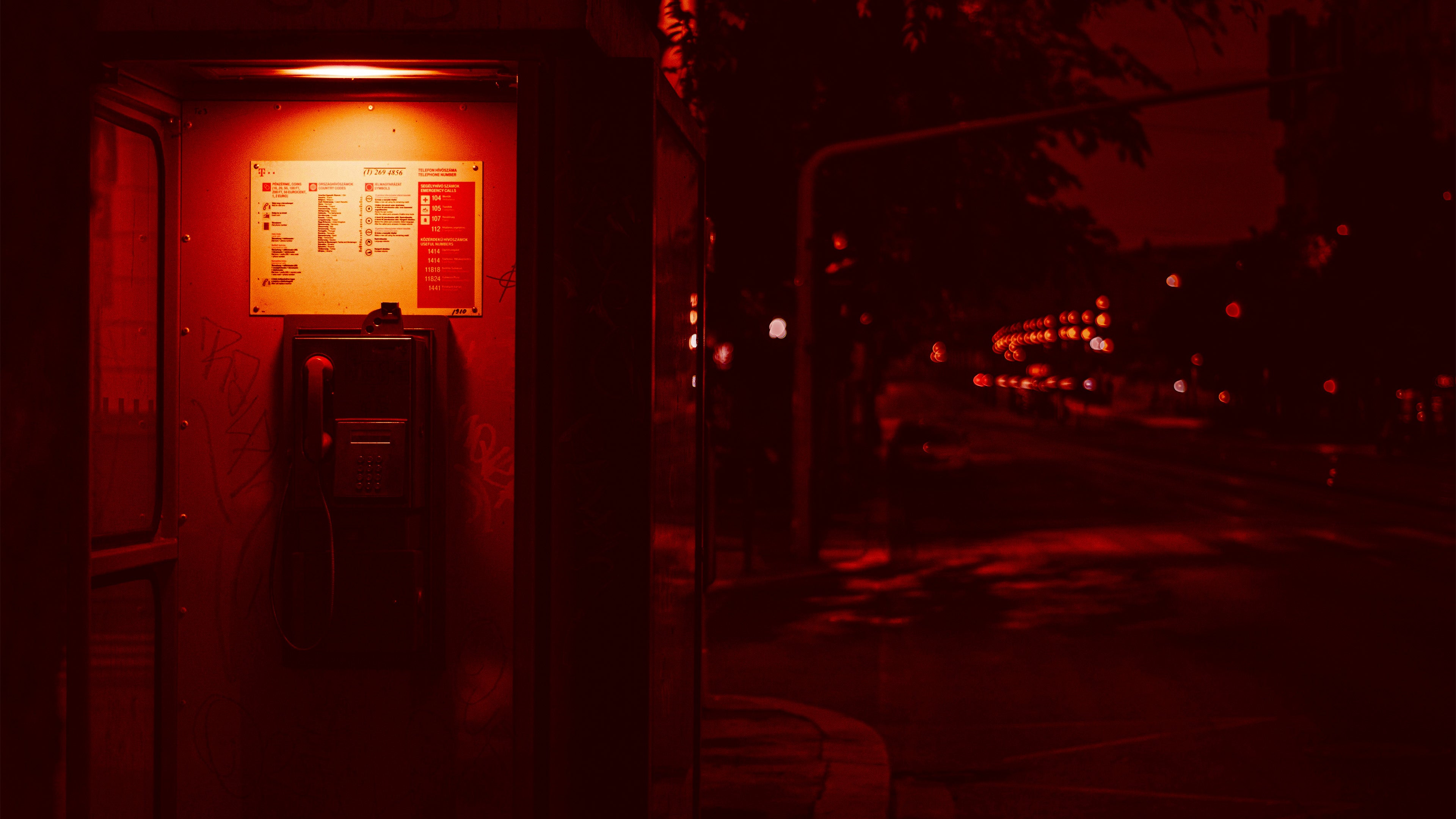 Red glows under your boots as you pass a shuttered deli and a forgotten payphone. You take a pull of cherry and everything slows. You can feel the city breathe