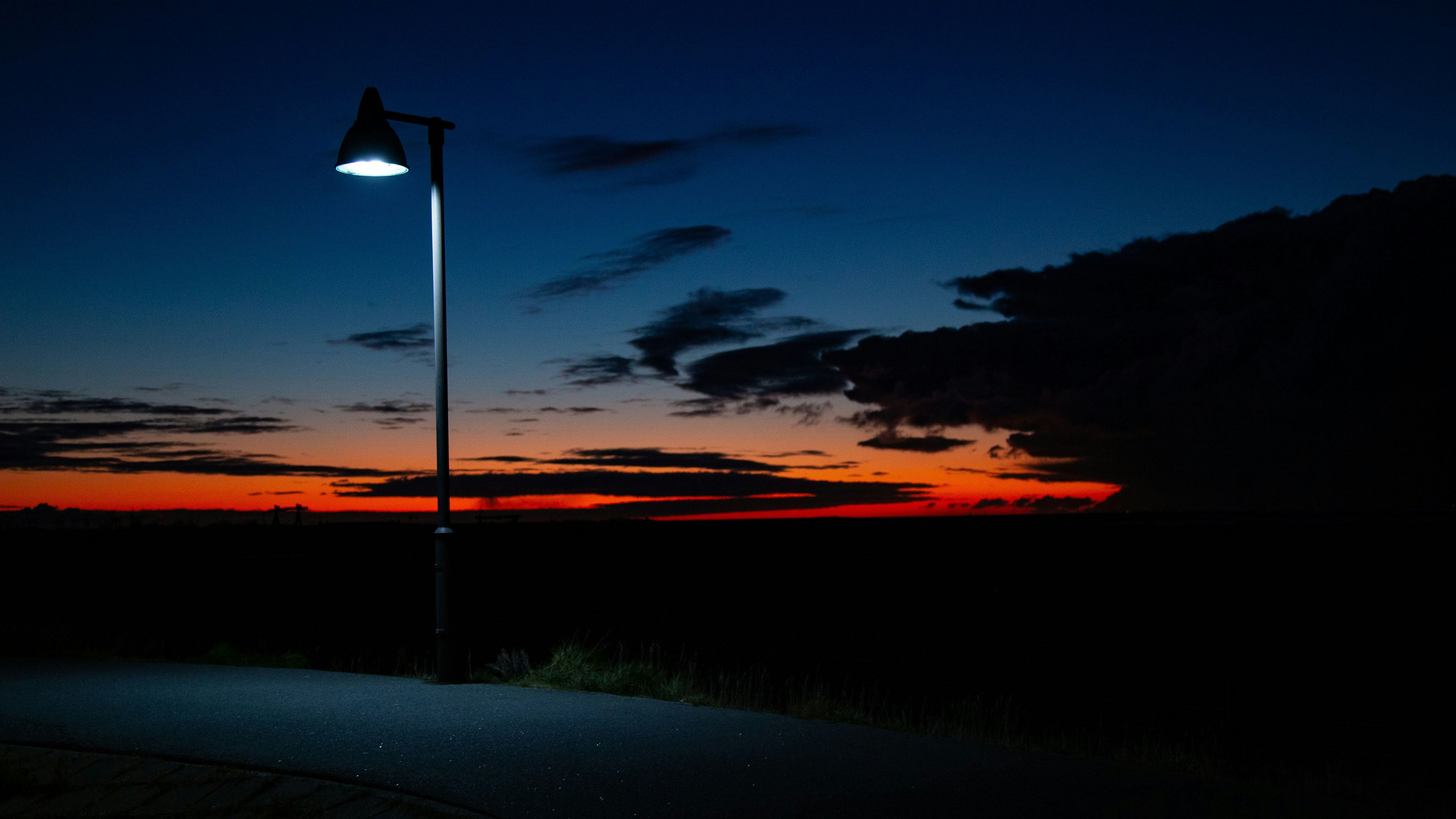 A blinking streetlight. A gas station with no pumps. The air buzzes with electric silence.It's red like an old photo, warm like rewound tape. <strong>And it always hits.</strong>